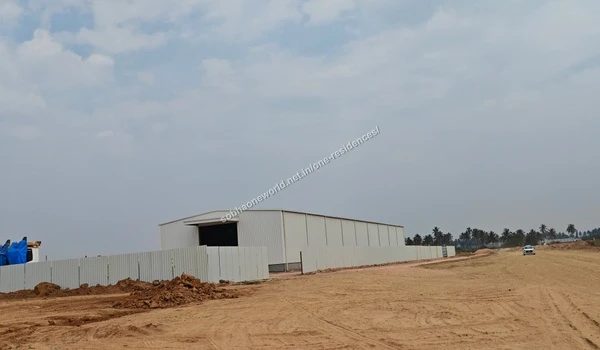 Temporary marketing office building under construction on the extensive grounds of Sobha One Residences featuring perimeter hoarding