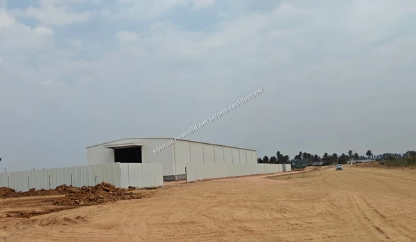 Exterior view highlighting the perimeter fencing and ongoing work at the Sobha One Residences project office