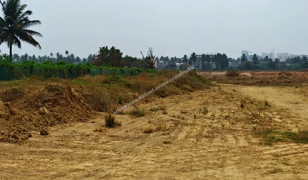 Excavated Earth Substantial mounds of reddish excavated earth with preserved greenery in the background at Sobha One Residences