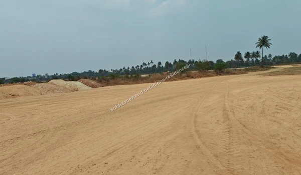 Reddish Earth Stockpile Large pile of reddish excavated earth surrounded by natural greenery at the Sobha One Residences plot