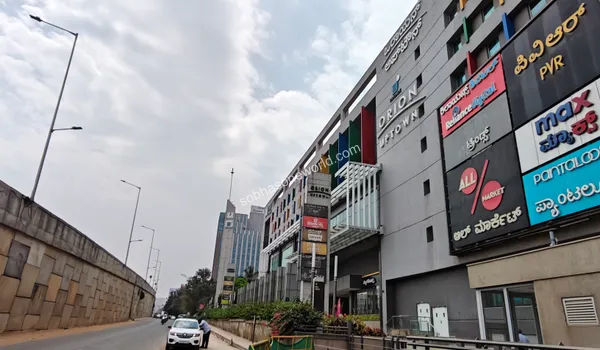 The bustling retail avenue and pedestrian-friendly zones established right outside the major mall supporting the Sobha One World neighborhood.