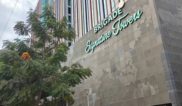 Upward view of the impressive corporate tower facade representing the massive office spaces available next to Sobha One World
