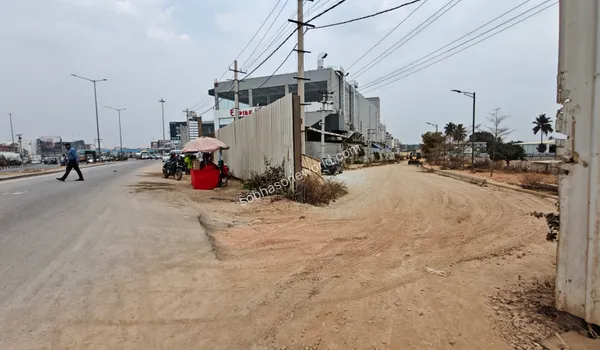 The inner unpaved access way leading deep into the Sobha One World construction area from the main public avenue.