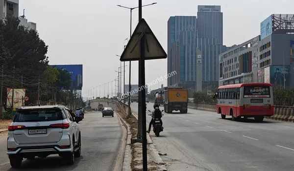 Highway view capturing the nearby Brigade Signature Towers and Orion Avenue along the route to Sobha One World