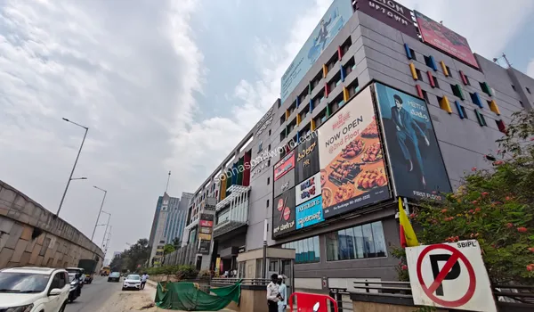 The expansive exterior of a premium shopping mall offering world-class retail and entertainment options near the Sobha One World community.