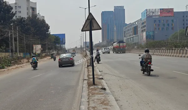 Wide access road leading towards the commercial hubs and the entrance of the Sobha One World property