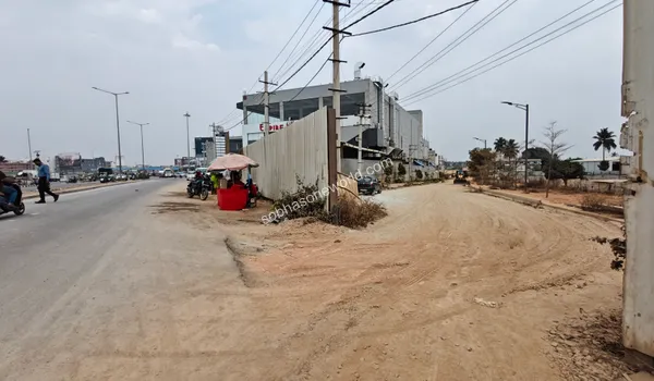The secure site enclosure and fencing running parallel to the active street near the Sobha One World construction zone.