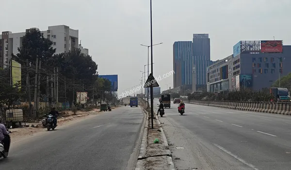 Extensive urban road network and overhead signage structures guiding towards the Sobha One World residential area